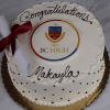 The GC-001N Boston College High School cake is round and white with black dots, topped with a diploma tied with a red ribbon and the BC High logo. "Congratulations Makayla" is written in black icing.