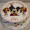 CB-002C is a round birthday cake featuring colorful polka dots, two balloon designs, and a cartoon mouse in a party hat made of frosting. The cake is inscribed with "Happy Birthday Leo!" in red icing.