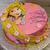 The CB-008G is a round pink birthday cake featuring Rapunzel from Tangled, yellow icing like her hair, pastel flowers, and "Happy Birthday Pippa" written in purple icing.