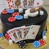 The GR-014 is a round black cake topped with fondant playing cards, poker chips, dice, and a small cigar, all arranged on and around the cake. It sits on a gold board.