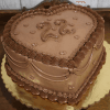 The CB-036B Heart Horoscope cake features a heart-shaped chocolate design with piped chocolate frosting, scalloped and swirled edges, small heart accents, and the number 22 on top, presented on a gold cake board.