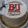 Celebrate with the GC-000C Boston University graduation cake—a round cake with "Congratulations Andrew," featuring the BU logo, mascot, diploma tied in black ribbon, and a quilted pattern with black dots.