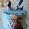 The CB-008C cake features a blue base with snowflakes, a large number 2 topper, Elsa and Anna “Frozen” figures, “Happy Birthday” on top, and a small topper of Elsa and Anna riding in a sleigh.