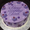 The CB-025E is a round purple birthday cake decorated with polka dots and cupcake designs, featuring "Happy Birthday Shree" in cursive icing on top, presented on a silver patterned board.