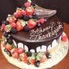 The THX-028 is a round chocolate-dripped cake topped with a cornucopia of strawberries, blackberries, and raspberries, featuring "Happy Thanksgiving" written in white icing.