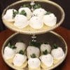 The ST-007-Bride Strawberries are white chocolate-dipped treats shaped like bunnies, featuring pink candy noses, dot eyes, and green leafy tops, beautifully arranged on a two-tiered gold serving tray.