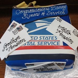 The BD-073 cake is decorated like a U.S. Postal Service package, with a blue banner reading "Congratulations Danny, 31 years of service," plus edible cards saying "Goodbye Tension" and "Hello Pension.