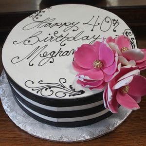 The BD-060B Hot Pink Magnolias cake features black and white stripes, pink flowers, and “Happy 40th Birthday Meghan” written in elegant script on top.