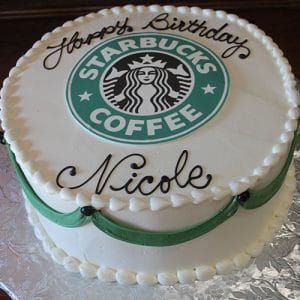 The BD-157 is a round birthday cake with the Starbucks Coffee logo on top, white icing, green side accents, and “Happy Birthday Nicole” written in black icing.