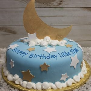 The CB-034 is a round blue birthday cake with white and gold stars, white frosting swirls, a large gold crescent moon topper, and "Happy Birthday Little Star" written in blue icing.