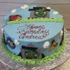 CB-011J is a round blue birthday cake with green icing trim, Angry Birds characters, and "Happy Birthday Andrew" in red icing on top. White fondant clouds and character faces decorate the sides.