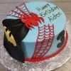 CB-006C: Round blue birthday cake with red spider webs, a red spider, Batman mask, and a number 3 on the side. "Happy Birthday Aiden" in yellow and black text. Red pearls decorate the base.