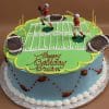 The SC-052 Football cake is round and features a football field, two player figurines, footballs, and goalposts. "Happy Birthday Brian" is written in red icing on top, with small football decorations on the sides.